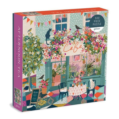 A 500 piece jigsaw puzzle box with a colorful illustration of a cafe with flowers, windows, and birds on it.